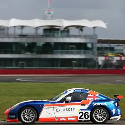 A Ginetta Junior in front of The Wing at Silverstone